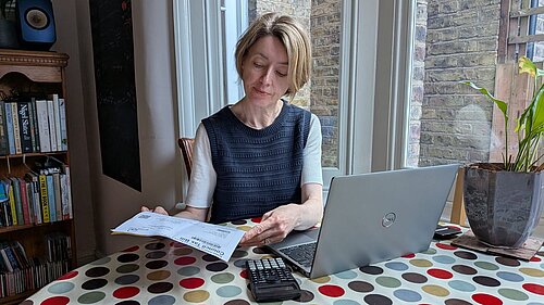Lib Dem campaigner Naomi McCarthy examining a recent Council Tax bill