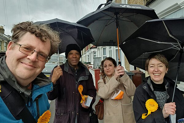 Happy Lib Dem volunteers in the rain