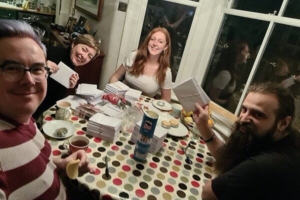 Liberal Democrat volunteers doing clerical work around a table