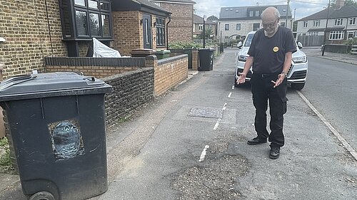 Liberal Democrat campaigner Alan Jones reporting potholes on Warwick Road